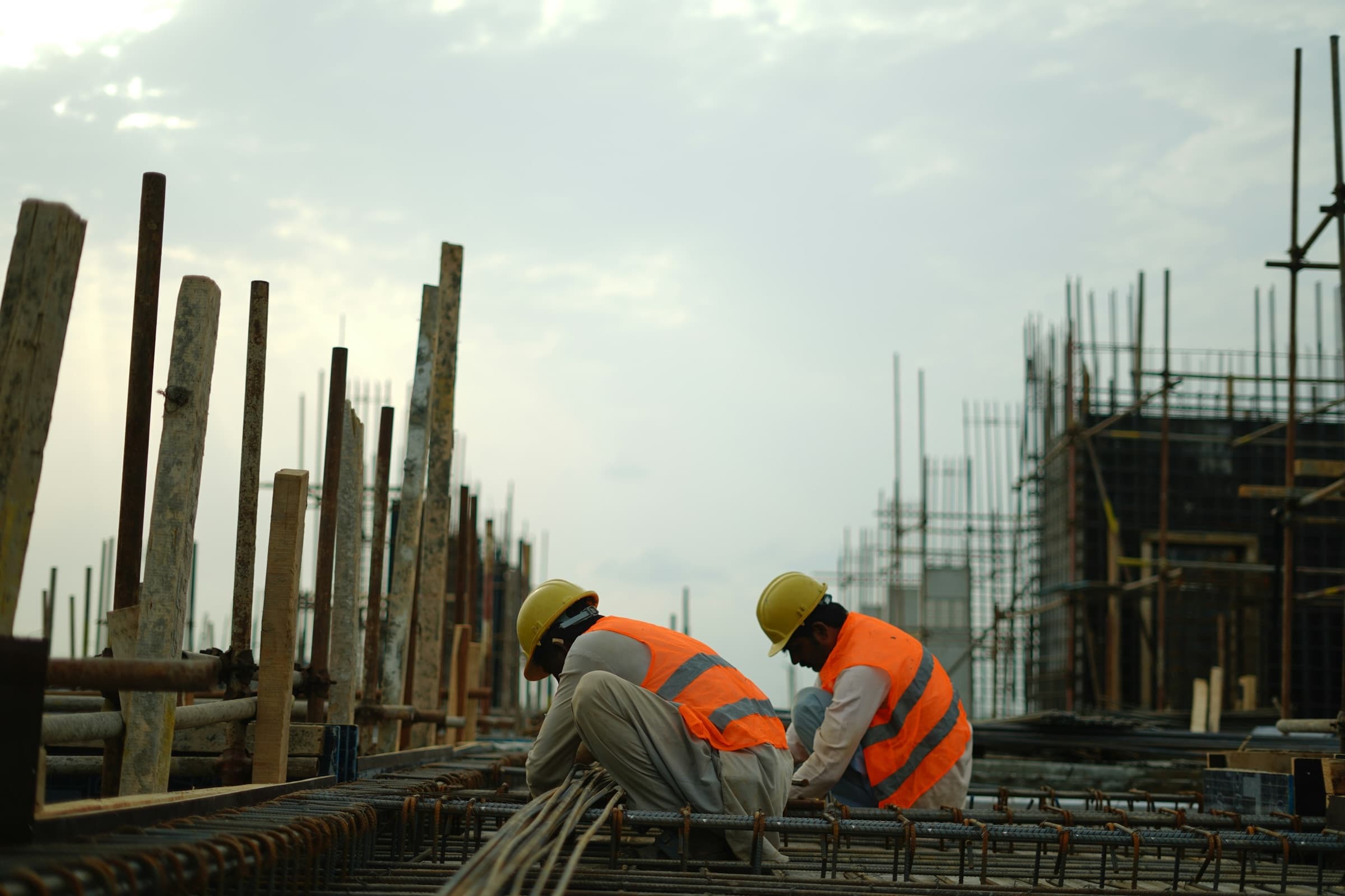 Construction workers in hard hats on a 9-Town building site